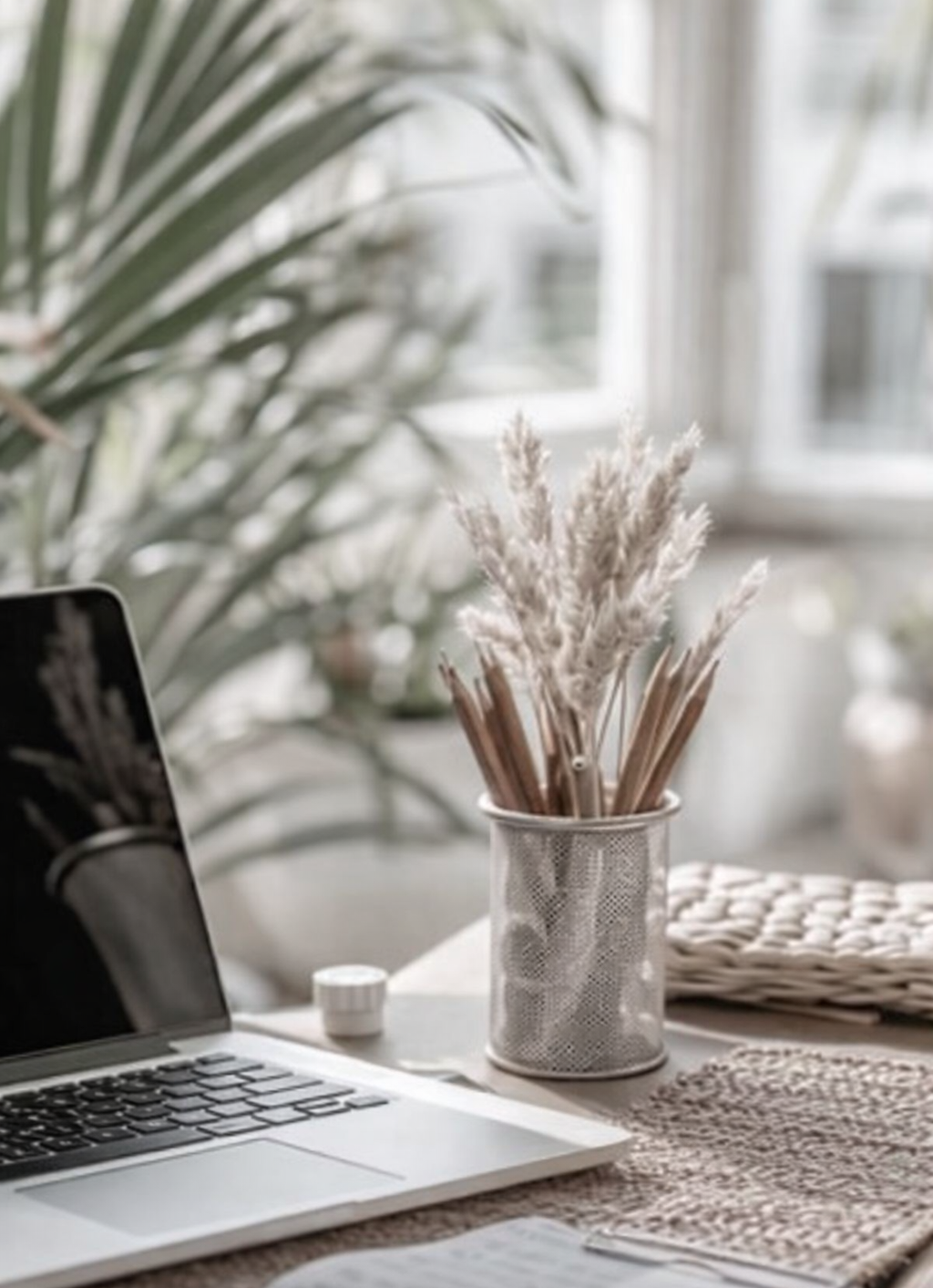 Calm workspace with laptop, pampas grass and notebook