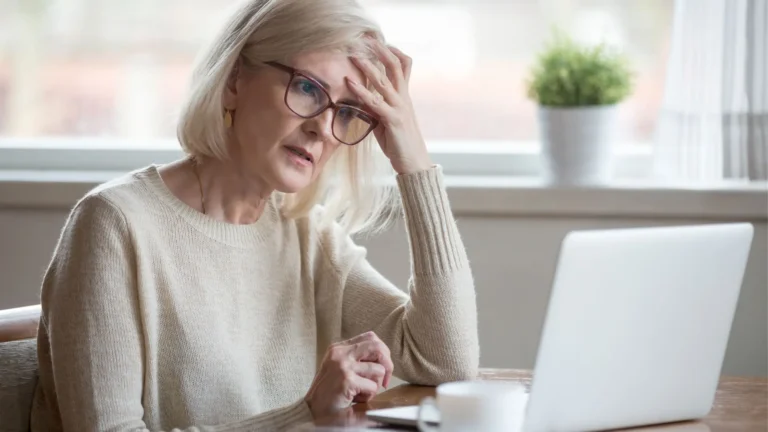 Middle ages woman looking for divorce help on her laptop