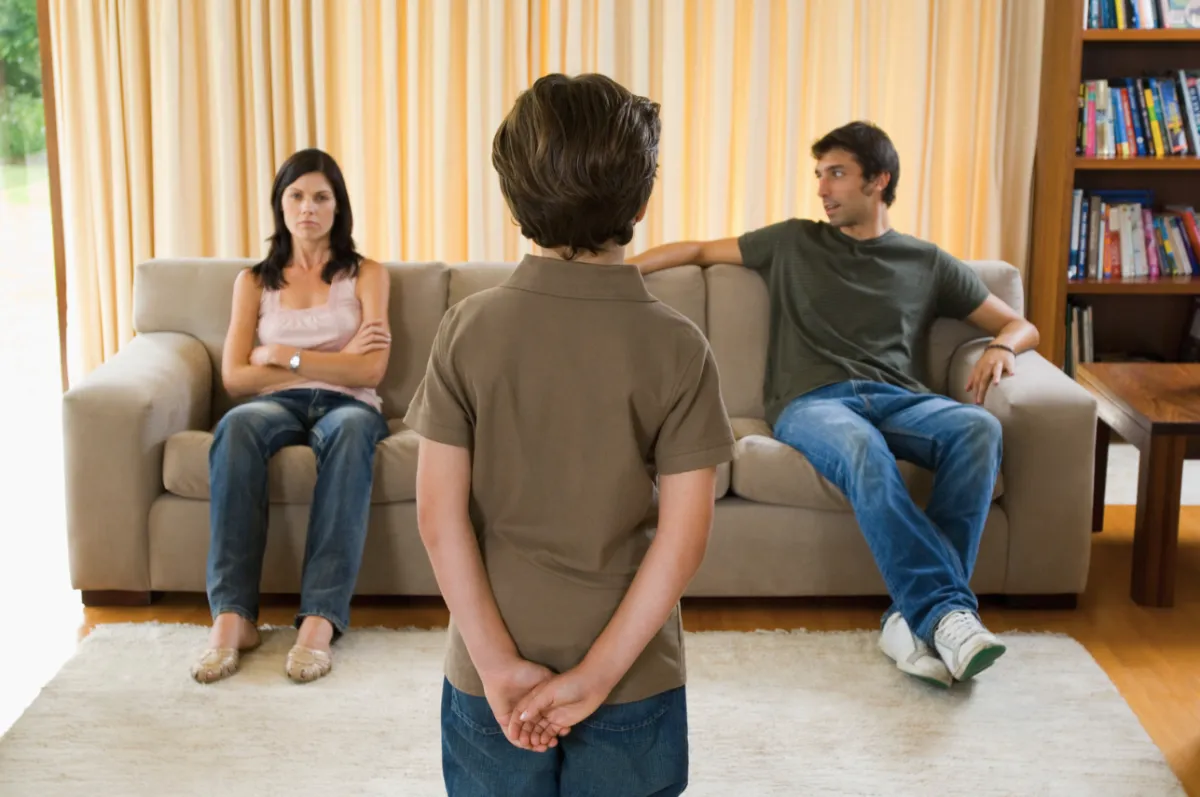 Young son watching parents not speaking with each other