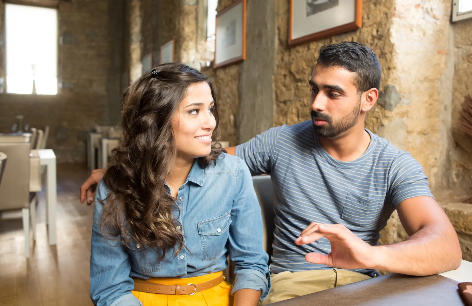 couple discussing a topic at a quiet cafe