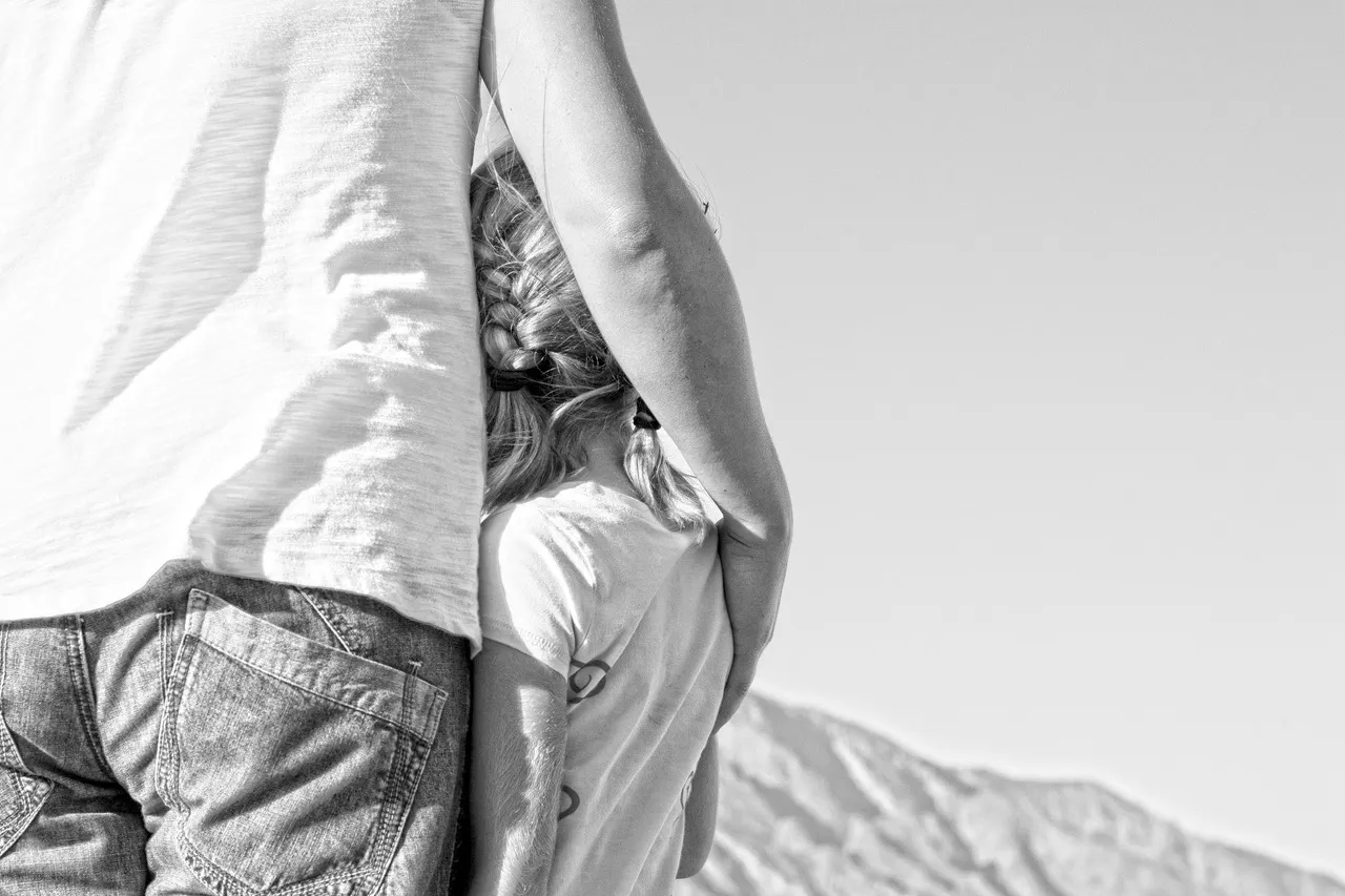 father and daughter outside embracing