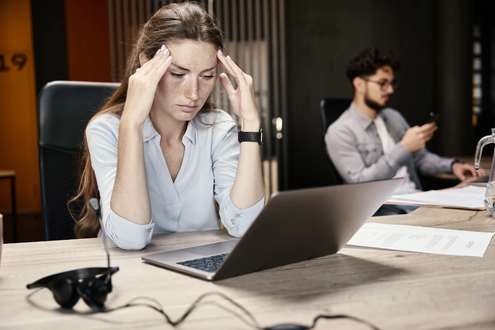 Female employee stressed in an office