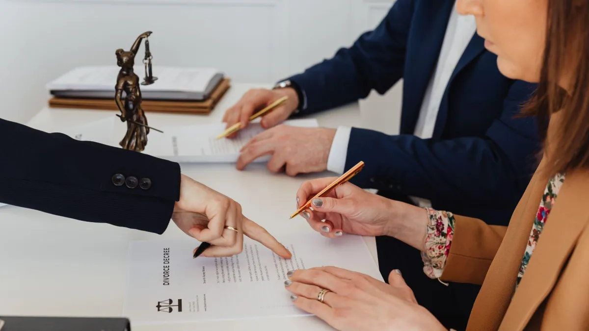 wife and husband signing divorce papers